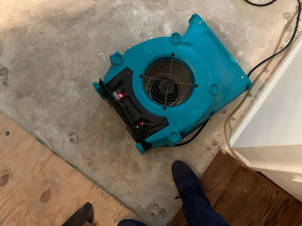 Air mover drying subfloor during Commercial Water Damage Restoration in Southport